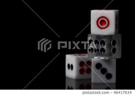 Closeup three dice stacked on dark background. Closeup three dice stacked on dark background. 46417634