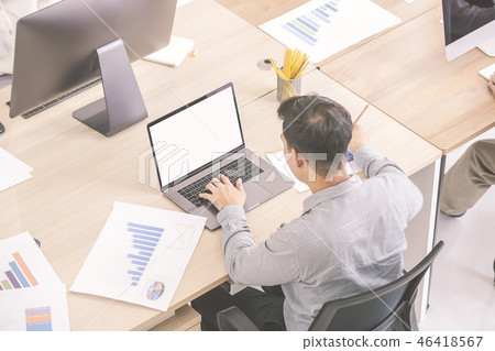 Man working on computer in office. 46418567