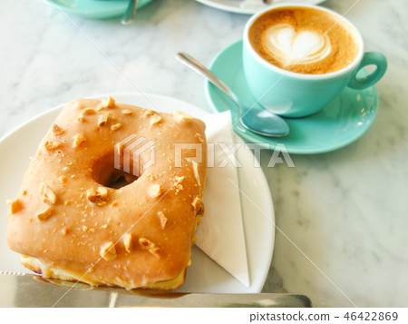 Cafe latte of peanut donut and heart which is popular in overseas cafe 46422869