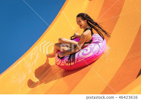 woman having fun on the water slide woman having fun on the water slide 46423616