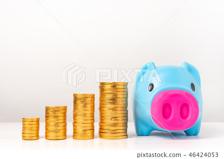 Blue piggy bank with piles of golden coins Blue piggy bank with piles of golden coins 46424053