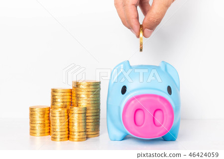 Male hand putting coin into blue piggy bank. 46424059