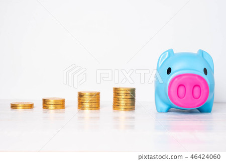 Blue piggy bank with piles of golden coins Blue piggy bank with piles of golden coins 46424060