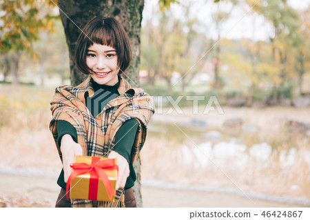 A woman giving a gift A woman giving a gift 46424867