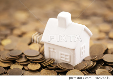 Small toy house on coins  46426610