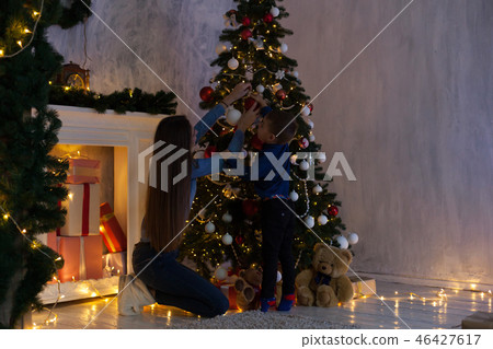 mom with son adorn the Christmas tree lights Christmas new year 46427617