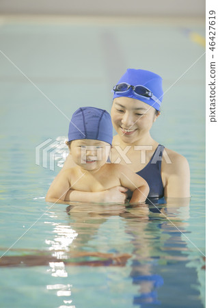 Boys and women playing in the pool Boys and women playing in the pool 46427619