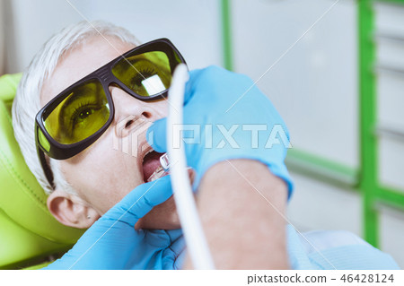 Laser Teeth Whitening Procedure. Senior Female Patient Going Thr Laser Teeth Whitening Procedure. Senior Female Patient Going Thr 46428124