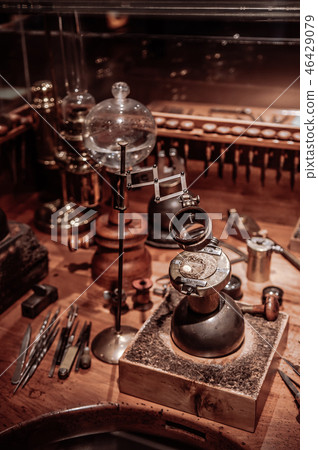 Old antique clockmaker table with tools 46429079