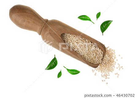 red quinoa seeds in wooden scoop decorated with green leaves isolated on white background. Top view red quinoa seeds in wooden scoop decorated with green leaves isolated on white background. Top view 46430702