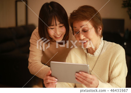 Senior woman learning to operate tablet terminal Senior woman learning to operate tablet terminal 46431987