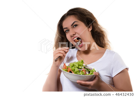 Hungry teen girl eating the salad with funny face 46432430