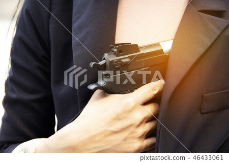 Close up women holding gun. Close up women holding gun. 46433061