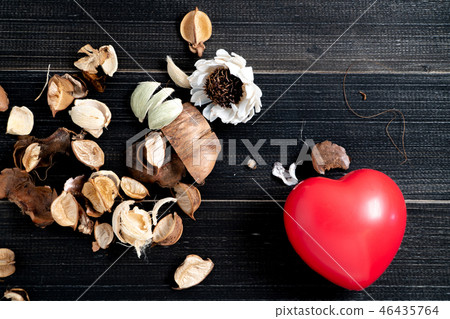 The red heart whit dried leaves and flower placed The red heart whit dried leaves and flower placed 46435764