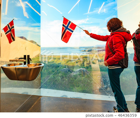 Tourist with norwegian flag in mirrored toilet, Andoy Norway 46436359