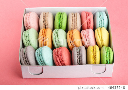 colorful macaroons in box on red white background closeup 46437248