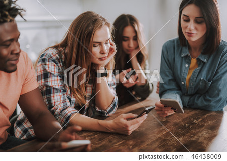 Young ladies and afro american guy using cellphones Young ladies and afro american guy using cellphones 46438009