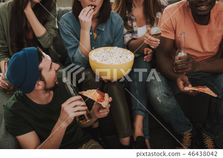 Young people eating and drinking while spending time together at home 46438042