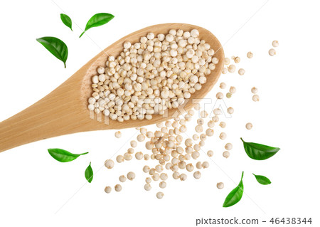 red quinoa seeds in wooden spoon decorated with green leaves isolated on white background. Top view 46438344