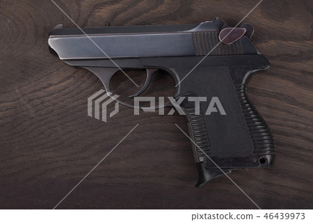 handgun on the wooden table 46439973