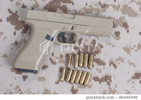handgun on camouflage uniform 46440440