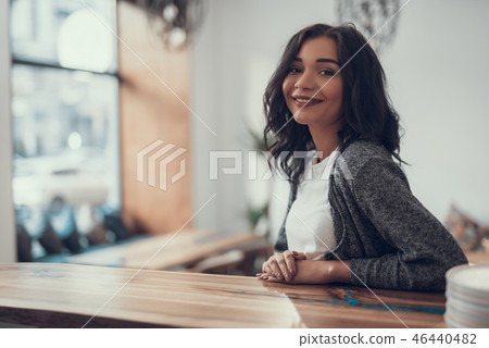 Cheerful lady putting hands on the bar counter and smiling 46440482