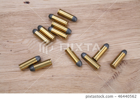 The .45 Revolver cartridges on wooden background The .45 Revolver cartridges on wooden background 46440562