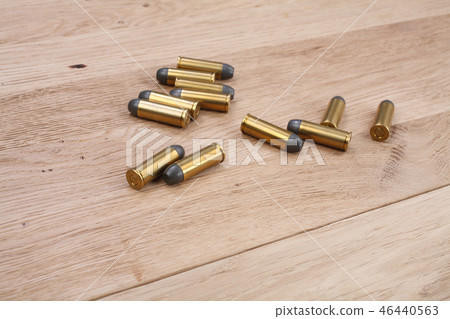 The .45 Revolver cartridges on wooden background The .45 Revolver cartridges on wooden background 46440563