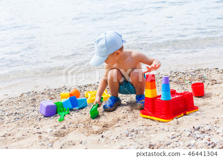 Close view of small boy having fun on a sandy beach Close view of small boy having fun on a sandy beach 46441304