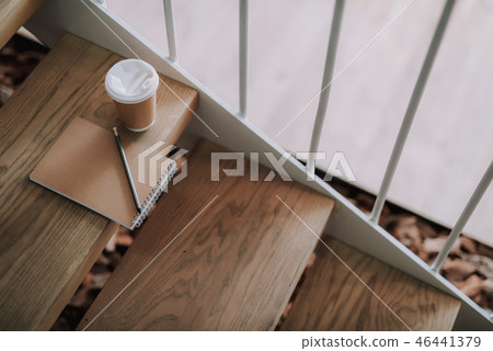 Paper coffee cup and notebook with pencil waiting for owner Paper coffee cup and notebook with pencil waiting for owner 46441379