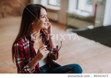 Attractive young lady in shirt talking on cellphone Attractive young lady in shirt talking on cellphone 46441427