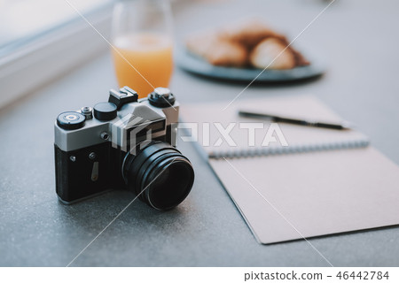 Selective focus of a photo camera lying on the table 46442784