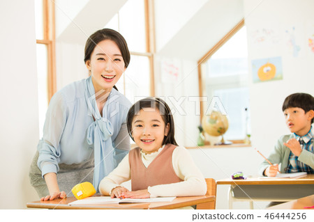 Young Students In Math Class With A Female Teacher Young Students In Math Class With A Female Teacher 46444256