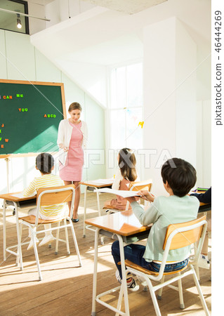 Female Teacher Teaching English To Young Students Female Teacher Teaching English To Young Students 46444269