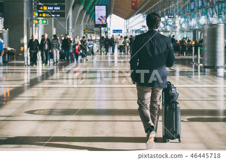 Businessman carrying suitcase in airport. Businessman carrying suitcase in airport. 46445718