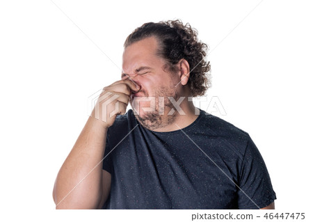 A young man holds or pinches his nose shut because 46447475