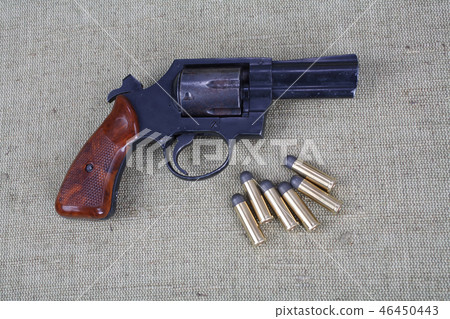 Revolver with ammunition on the canvas background 46450443