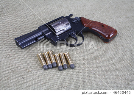 Revolver with ammunition on the canvas background 46450445
