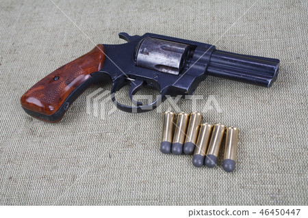 Revolver with ammunition on the canvas background 46450447