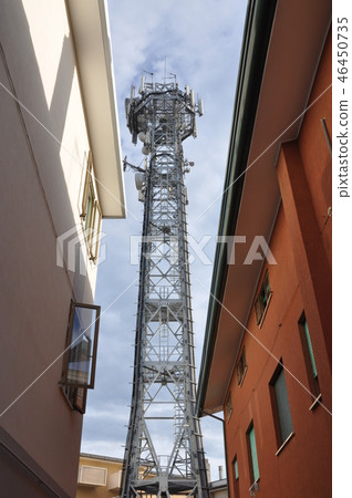 Telecommunication tower in urban space 46450735