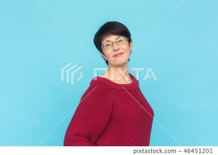 Fashion, style and people concept - smiling pretty middle-aged woman on turquoise background Fashion, style and people concept - smiling pretty middle-aged woman on turquoise background 46451201