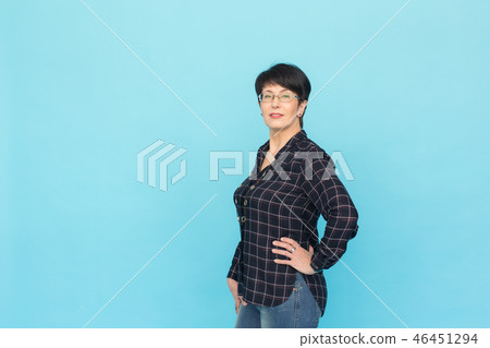 Modern woman and style concept - Beautiful mid-aged woman with short hair on blue background with Modern woman and style concept - Beautiful mid-aged woman with short hair on blue background with 46451294