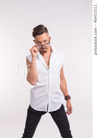 Expression and people concept - young handsome man looking at you through the glasses on white 46453311