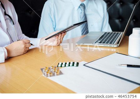 Patient listening intently to a male doctor 46453754