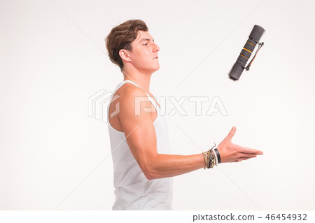 Expression, fitness and people concept - Handsome man throwing up a dumbbell over white background Expression, fitness and people concept - Handsome man throwing up a dumbbell over white background 46454932