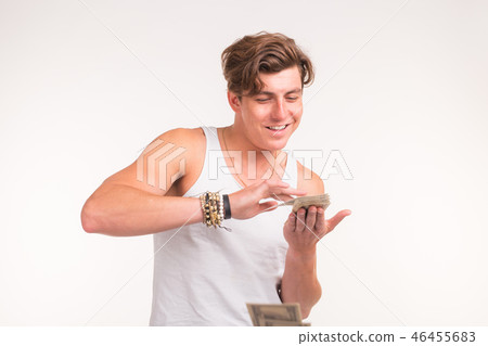 Concept of financial wealth, prosperity and lottery winnings - Man throwing away his money on white 46455683