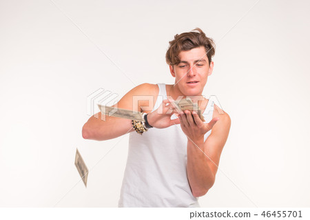 Concept of financial wealth, prosperity and lottery winnings - Man throwing away his money on white 46455701