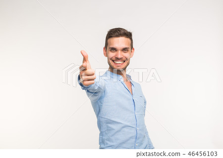 Portrait of stylish handsome young man with thumbs up isolated on white background 46456103