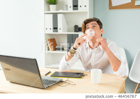 Joke, office, humor, people concept - handsome man chewing gum and thinking about something, huge Joke, office, humor, people concept - handsome man chewing gum and thinking about something, huge 46456767
