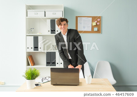 Business, joke, people concept - handsome young man in suit having fun in the office Business, joke, people concept - handsome young man in suit having fun in the office 46457609